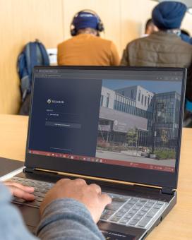 Person logging in on a laptop